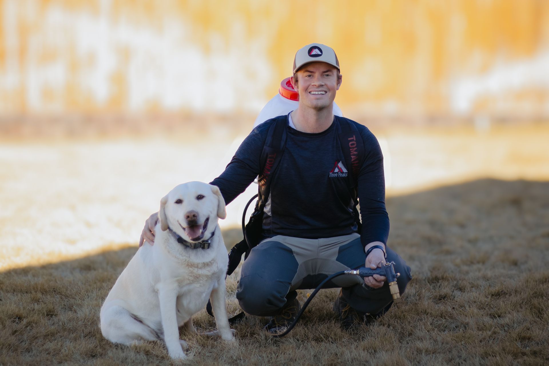 A Three Peaks Pest Control technician posing with a dog before spraying a home in Duck Creek, Utah. A Three Peaks Pest Control technician posing with a dog before spraying a home in Duck Creek, Utah.