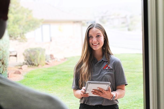 A pest control inspector from Three Peaks Pest Control meets with home owner in St. George.