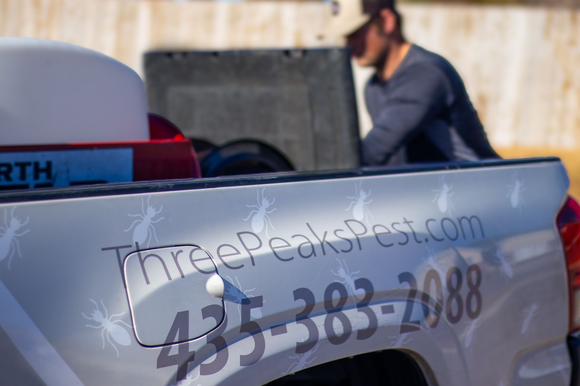A Three Peaks Pest Control Technician is inspecting his equipment in Enoch.