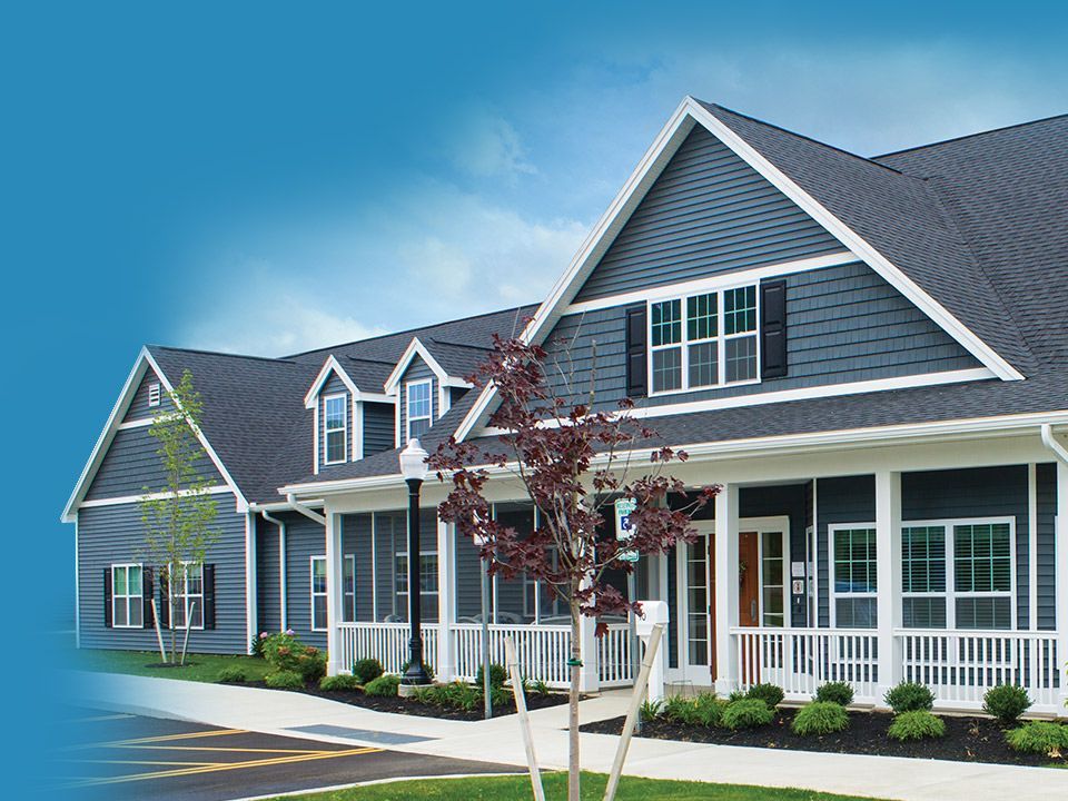 a row of houses with a blue sky in the background