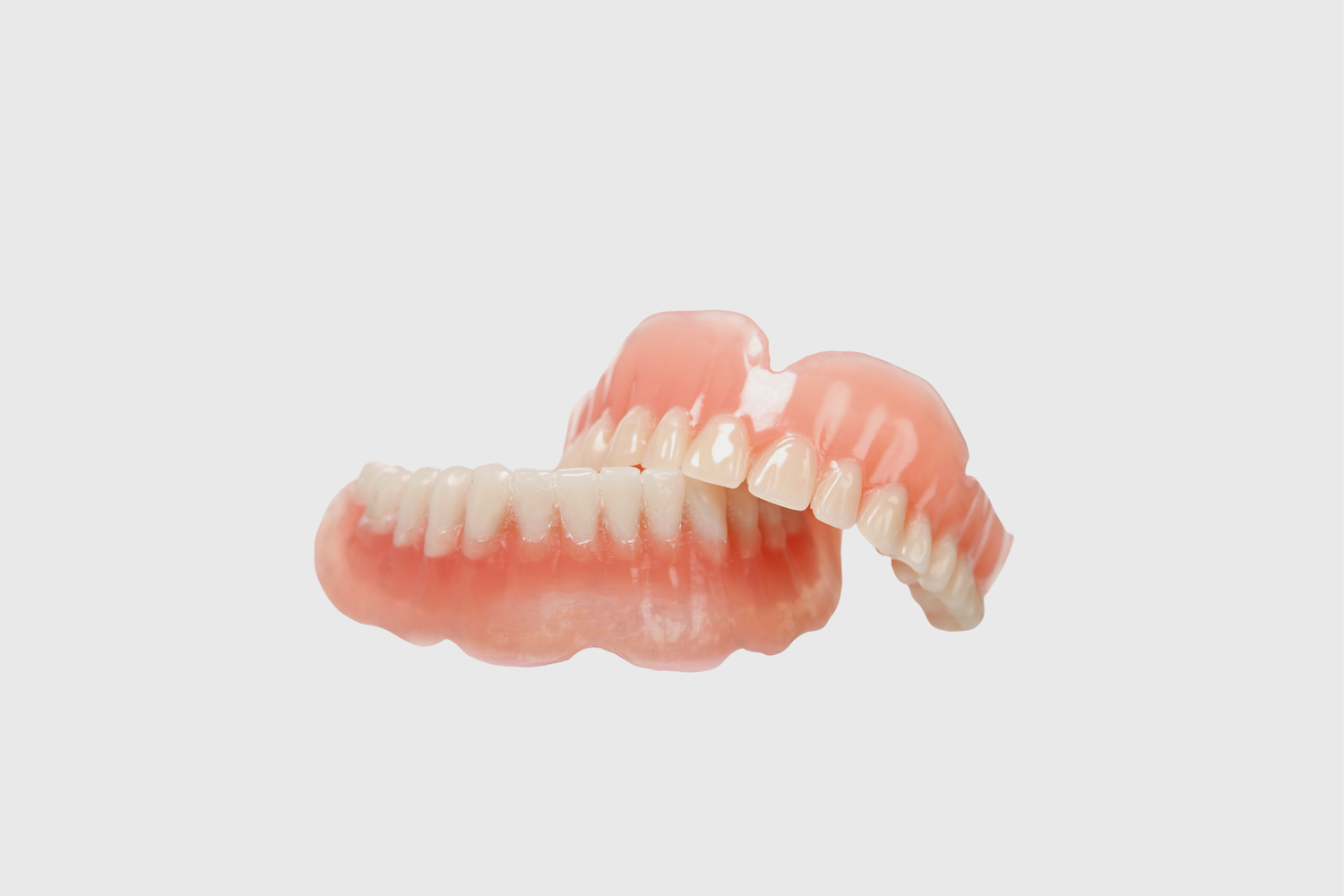 Dentist pointing at teeth on a screen during a consultation in an office.