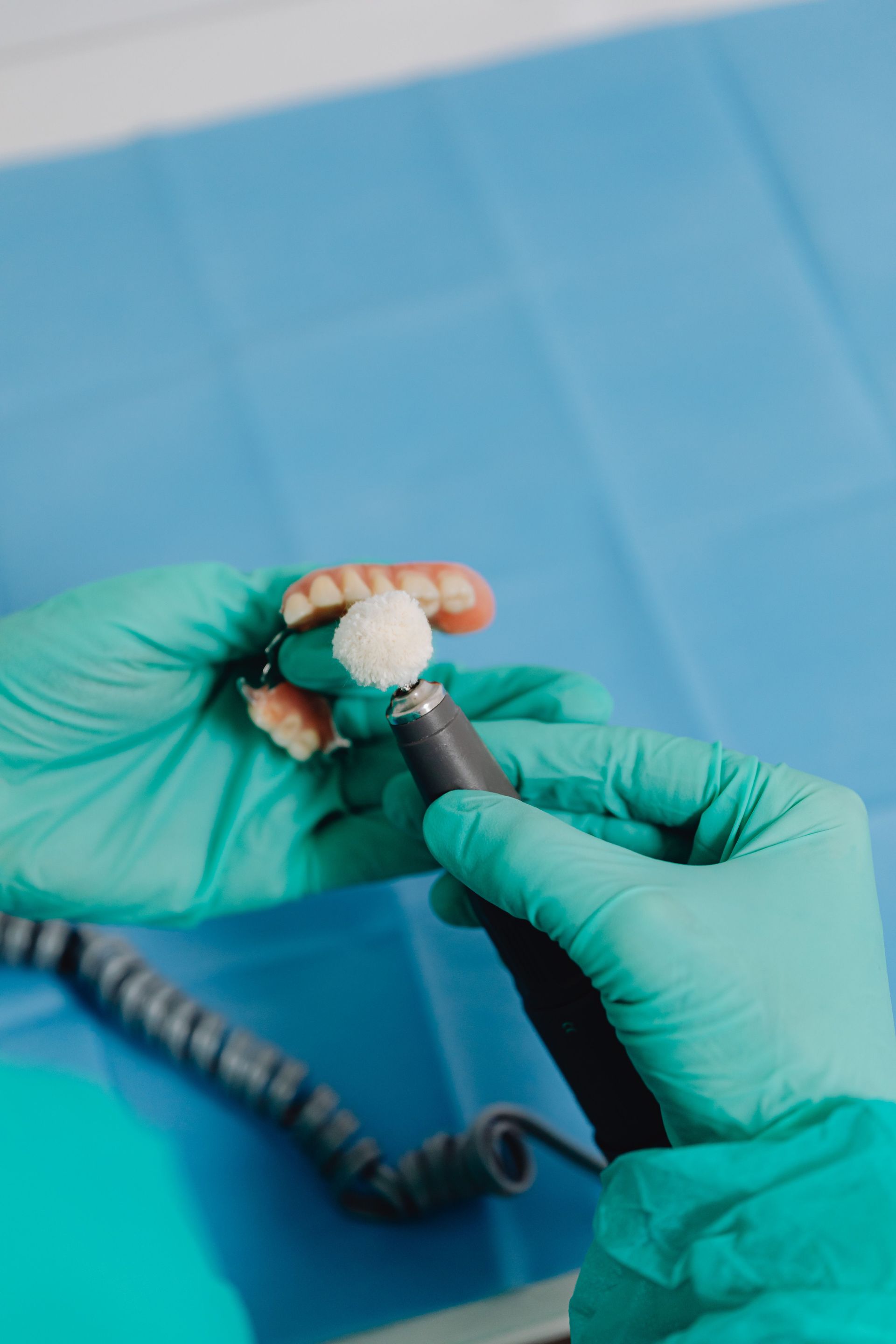 Dentist pointing at teeth on a screen during a consultation in an office.