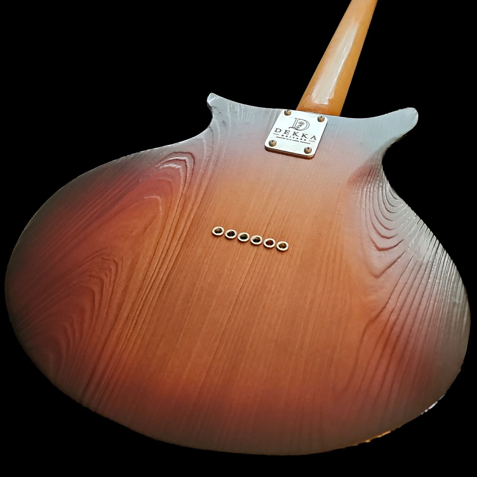 Sunburst guitar back with textured wood grain showing through a thin nitro finish