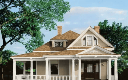 White Victorian-style house with a front porch, brown roof, and large green trees against a blue sky