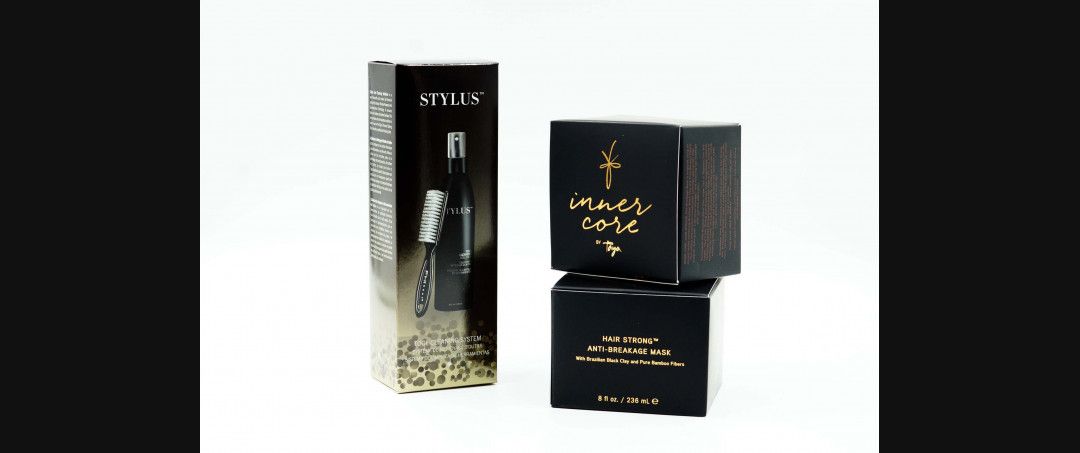 Black luxury perfume packaging with gold accents on a white background.