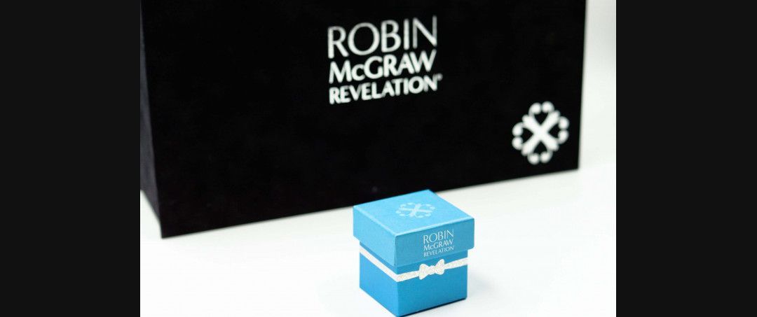 Robin McGraw Revelation black-and-white box with a small blue box in front on a white surface