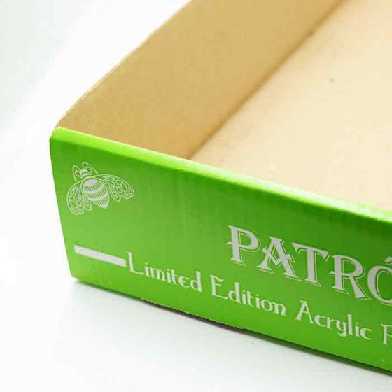 Green cardboard box with white text reading “PATRO… Limited Edition Acrylic…”