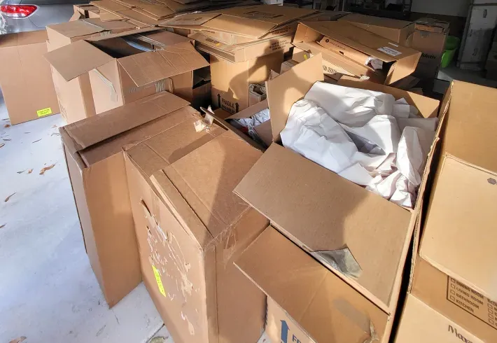 A bunch of cardboard boxes are stacked on top of each other
