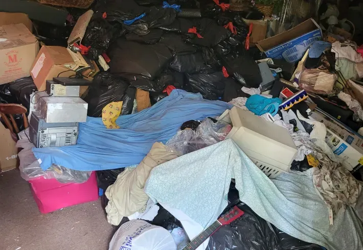 A pile of trash is sitting on the floor in a room.