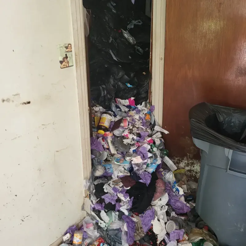 A room filled with garbage and a trash can