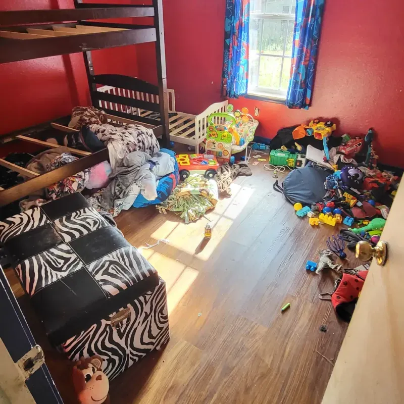 A bedroom with a bunk bed and a zebra print ottoman