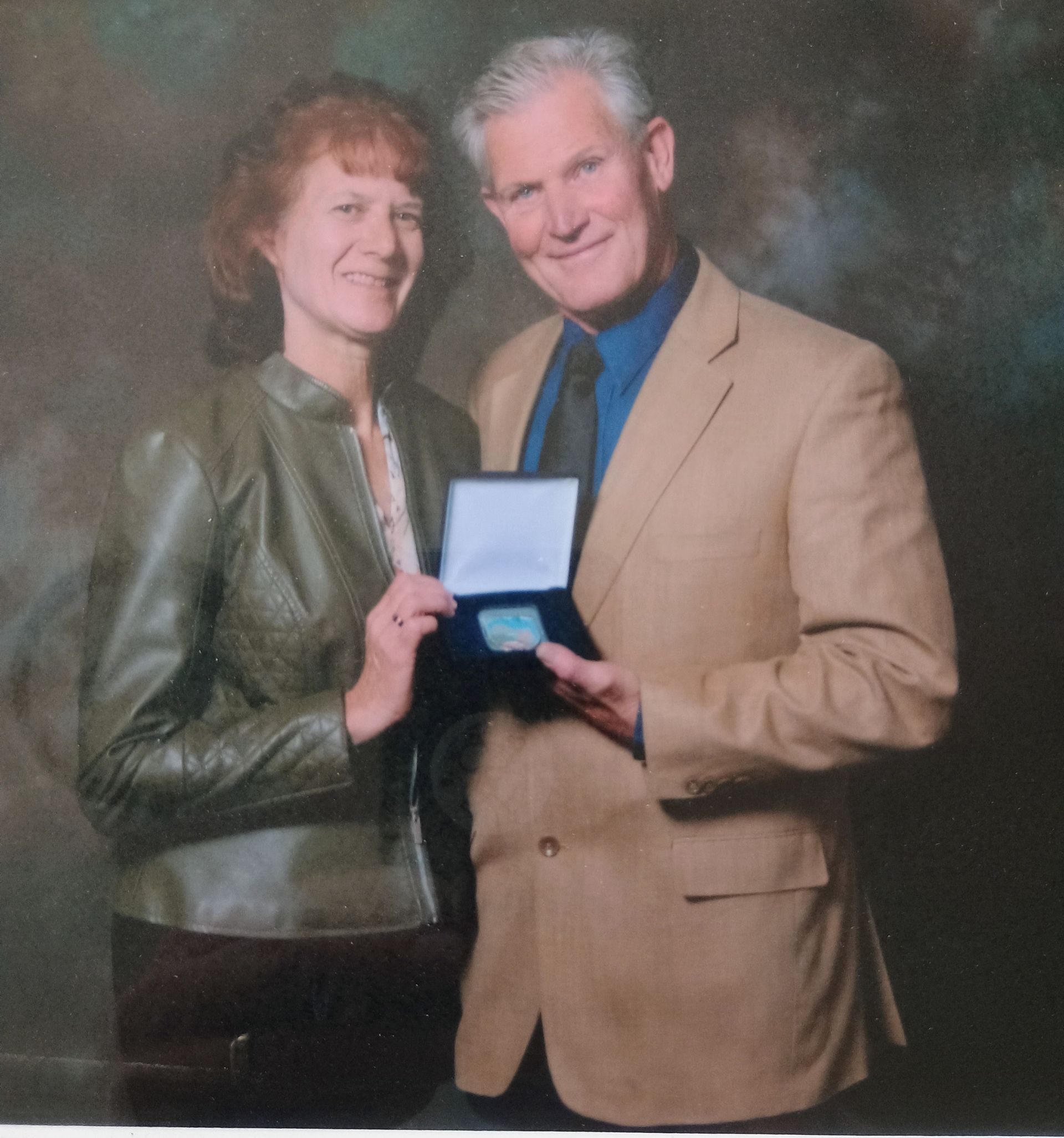 Dave Asher and wife Beth Williams receive the EDAWN coin.
