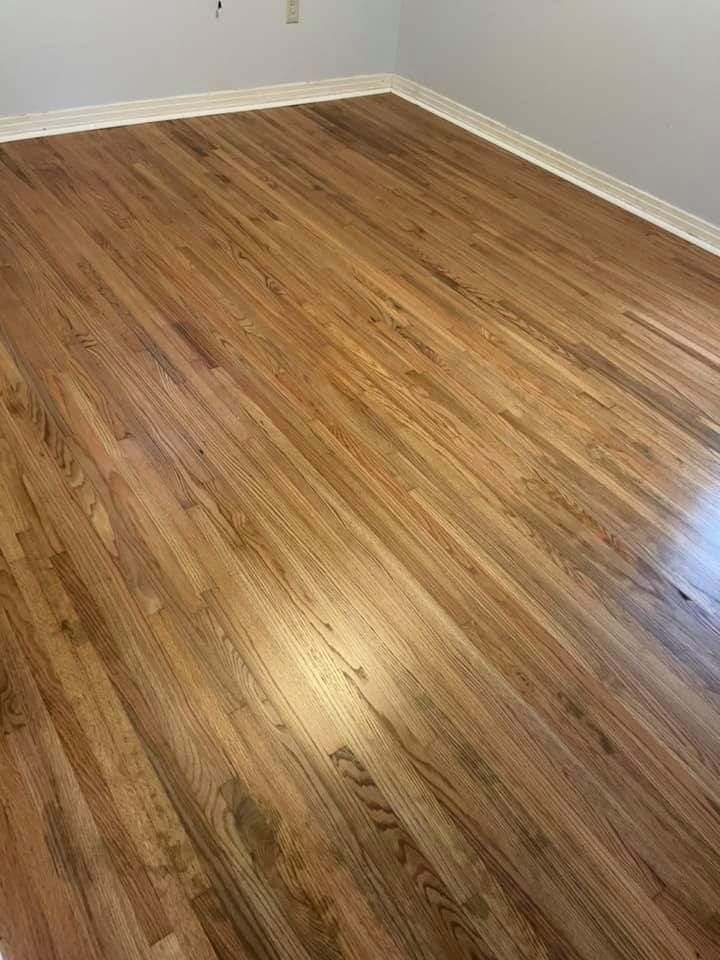 There is a large wooden floor in the middle of the room.