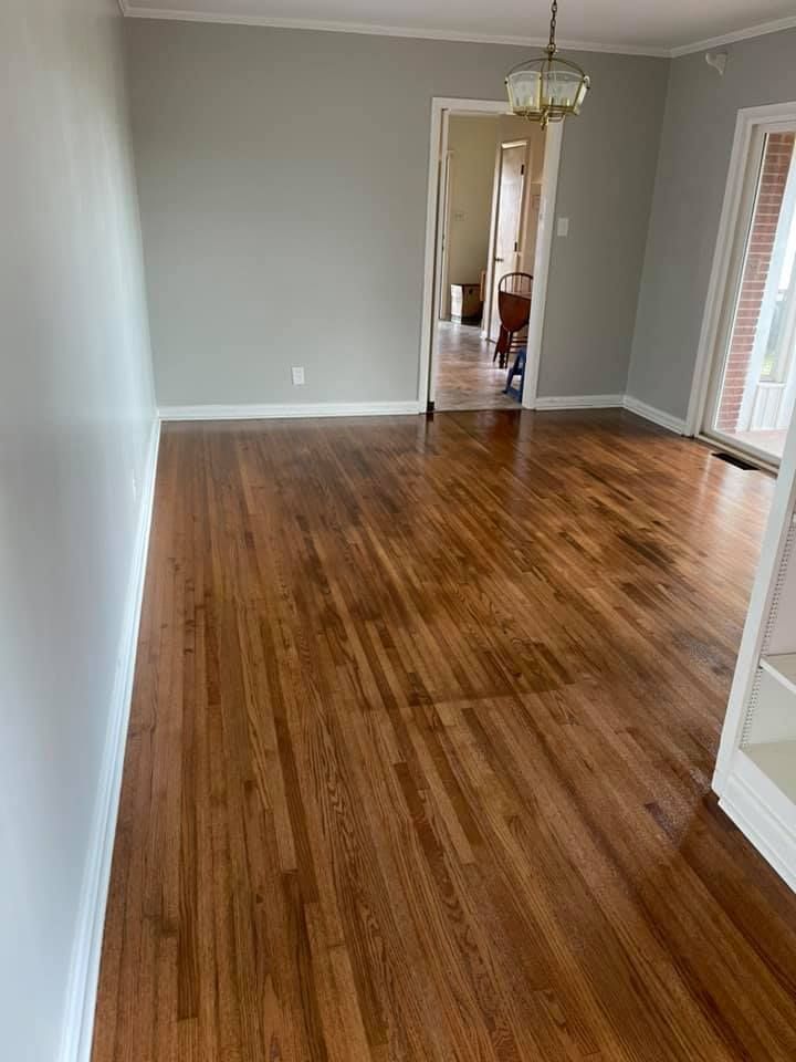 A living room with hardwood floors and gray walls.