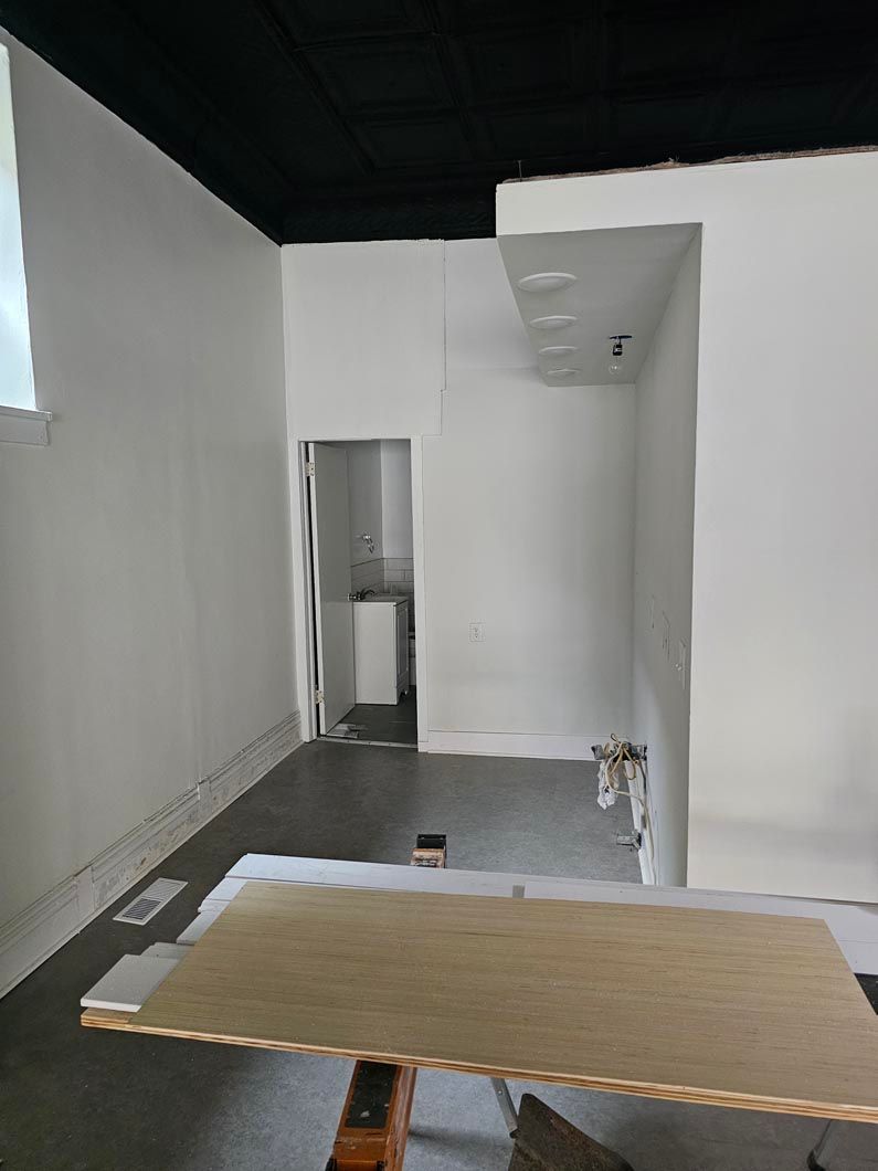 There is a wooden table in the middle of the room.