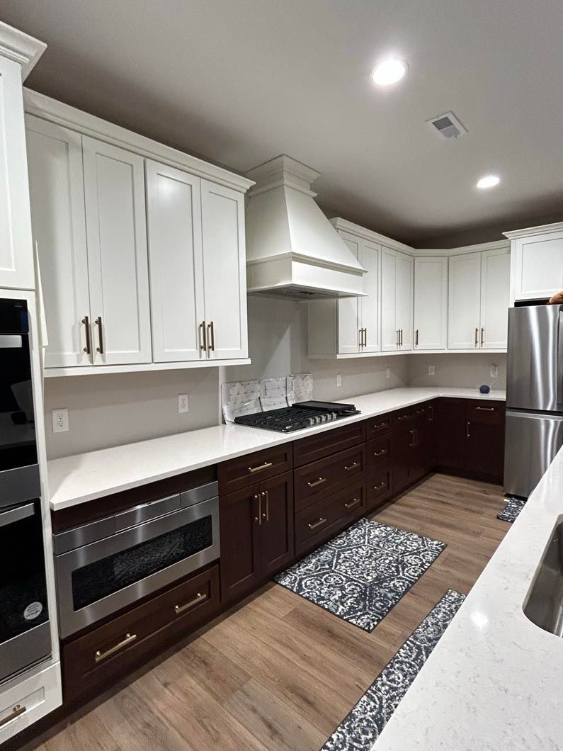 A kitchen with white cabinets and stainless steel appliances.