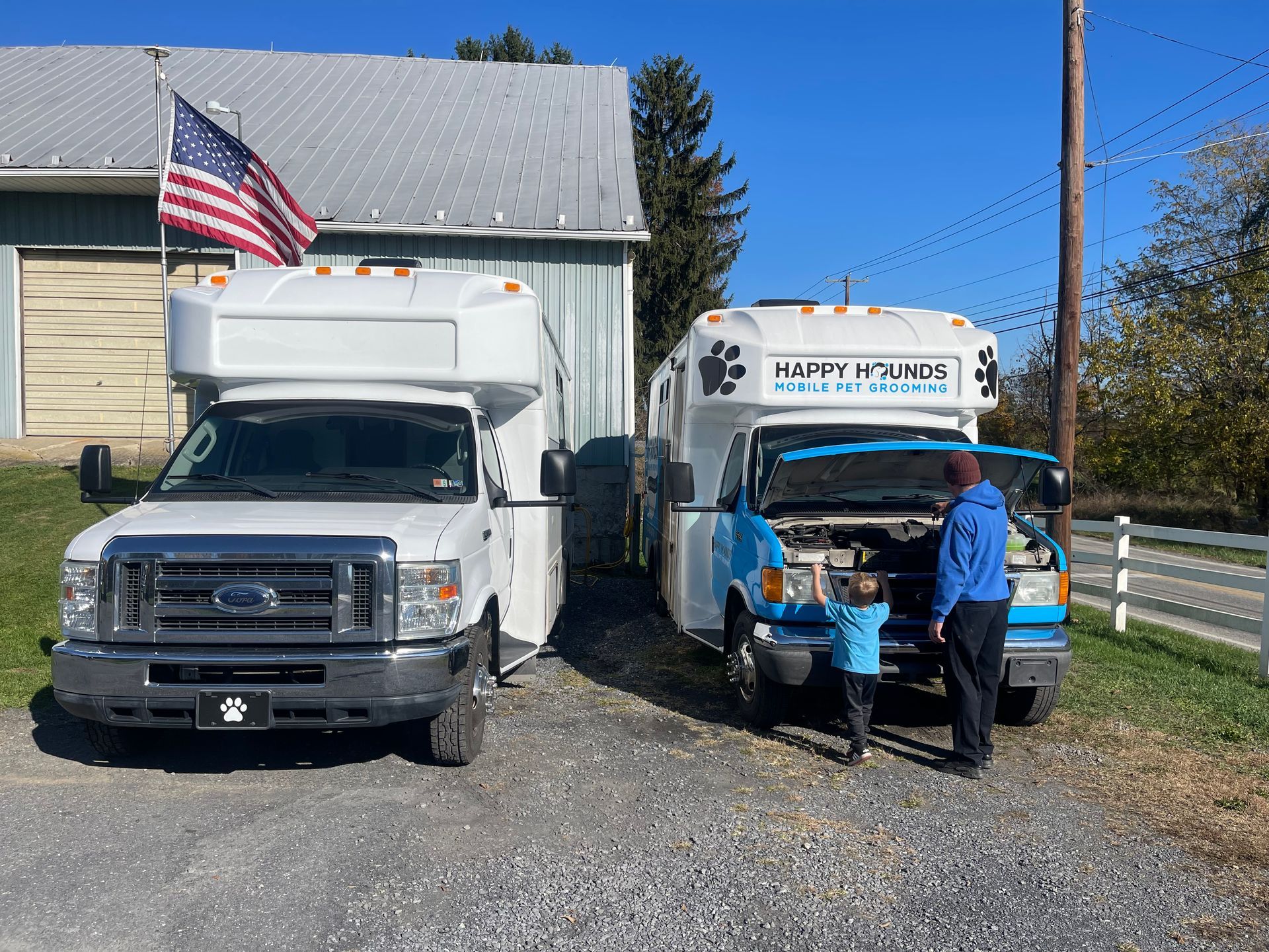 Two trucks are parked next to each other in front of a building.