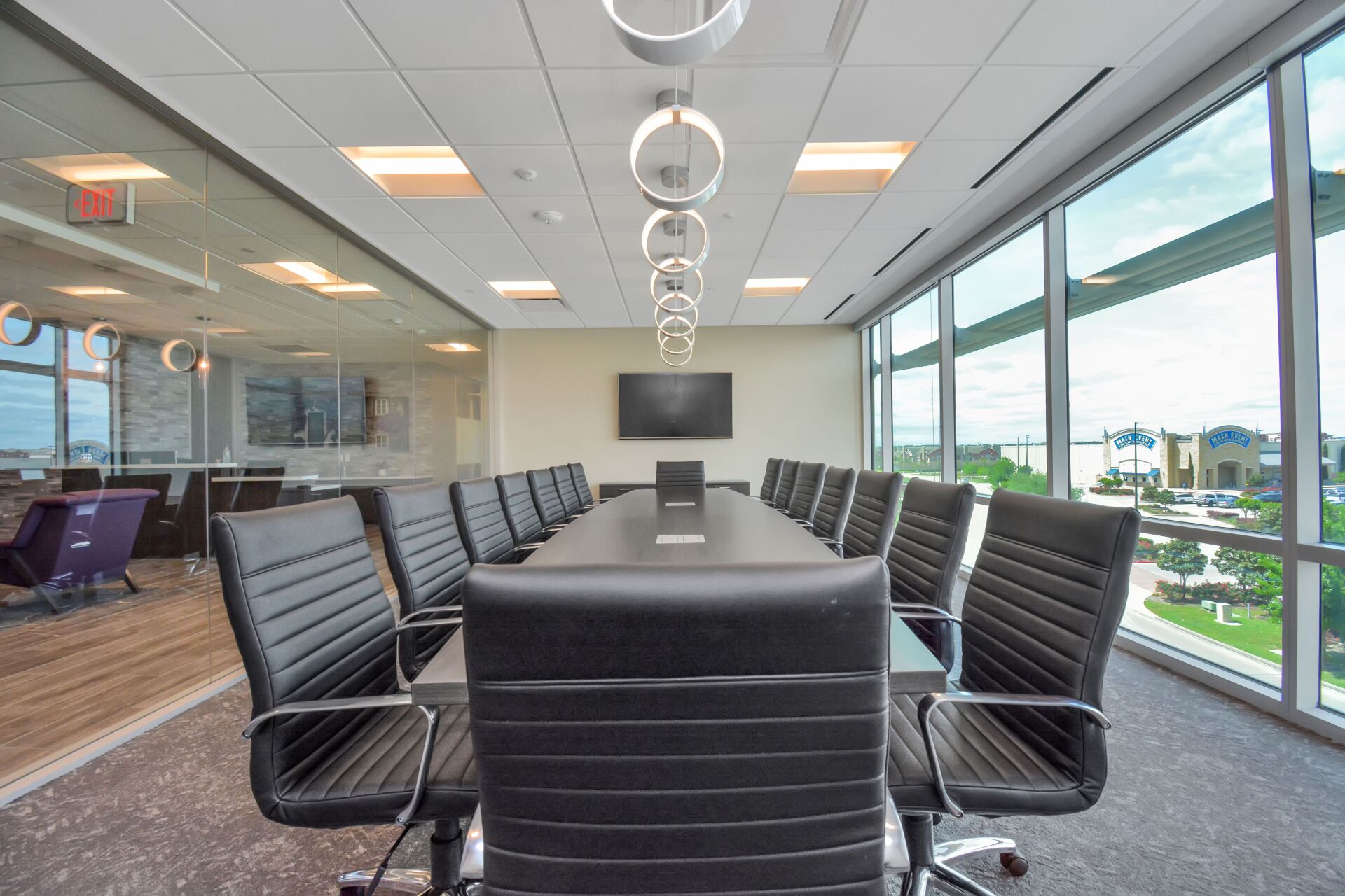 A conference room with a long table and chairs