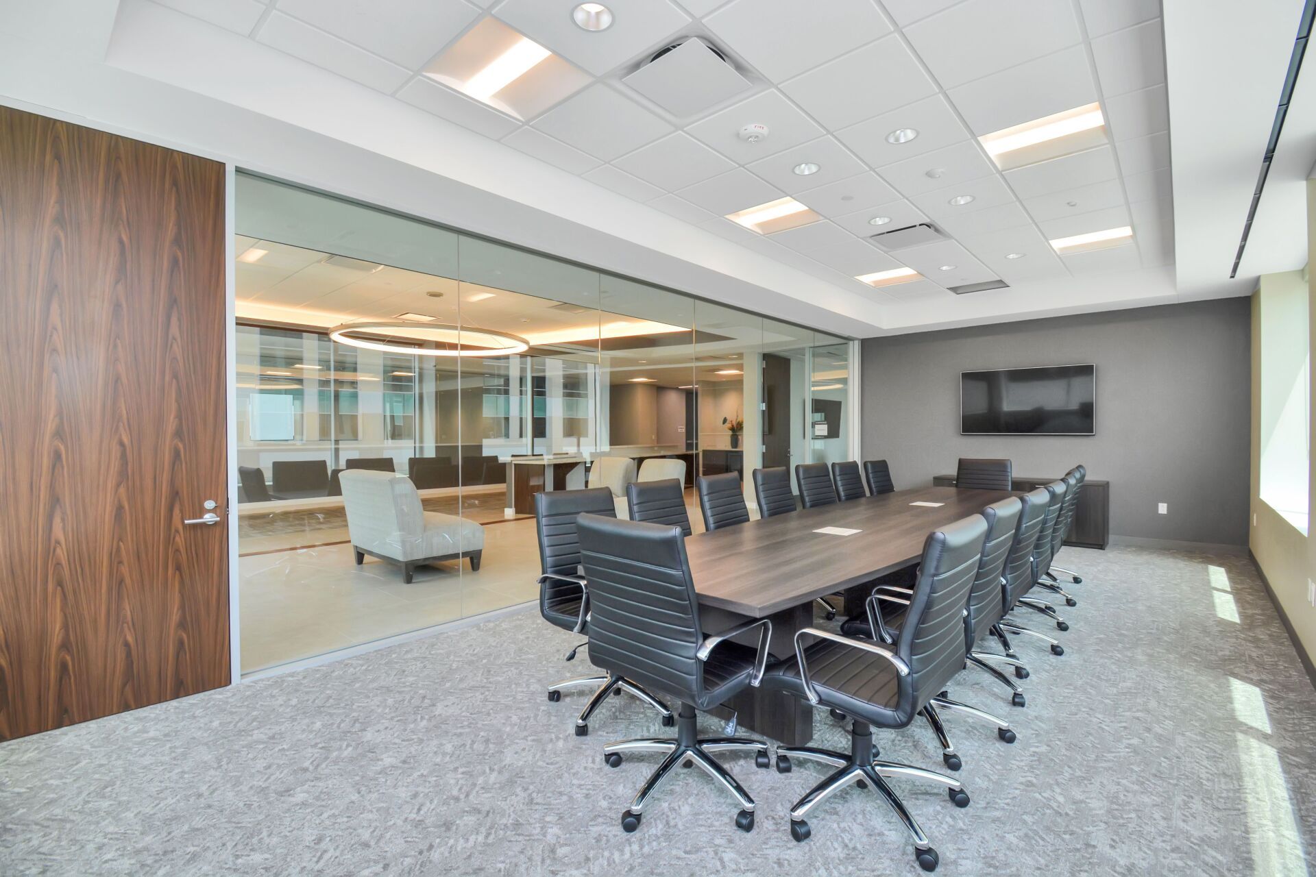 A large conference room with a long table and chairs.