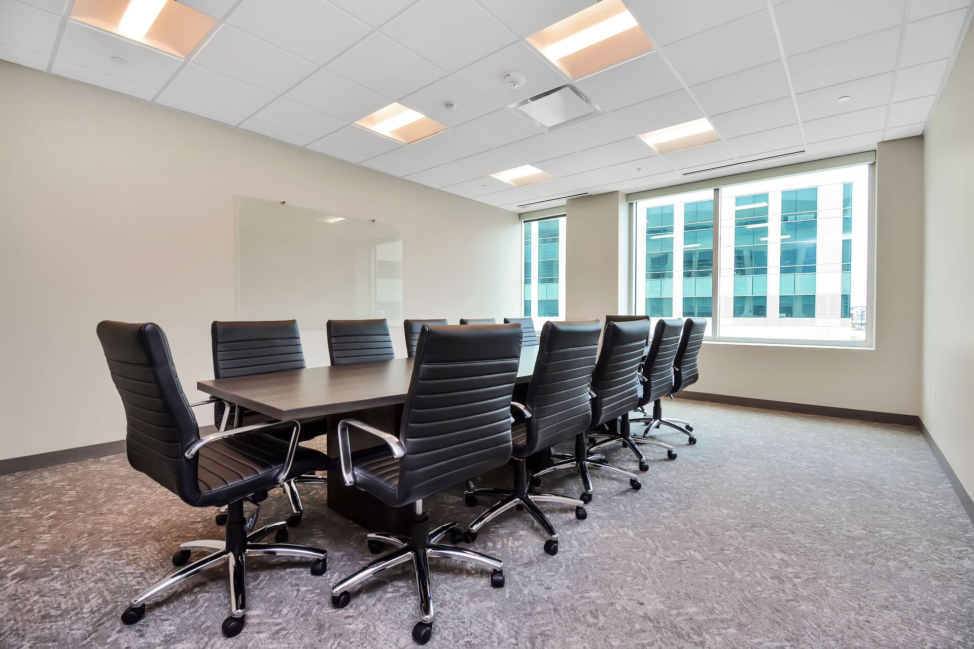 A conference room with a long table and chairs.