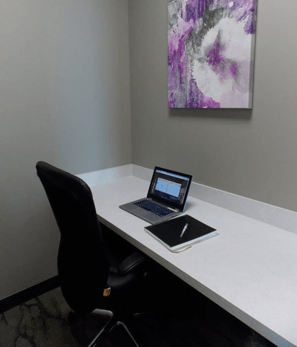 A desk with a laptop and a tablet on it