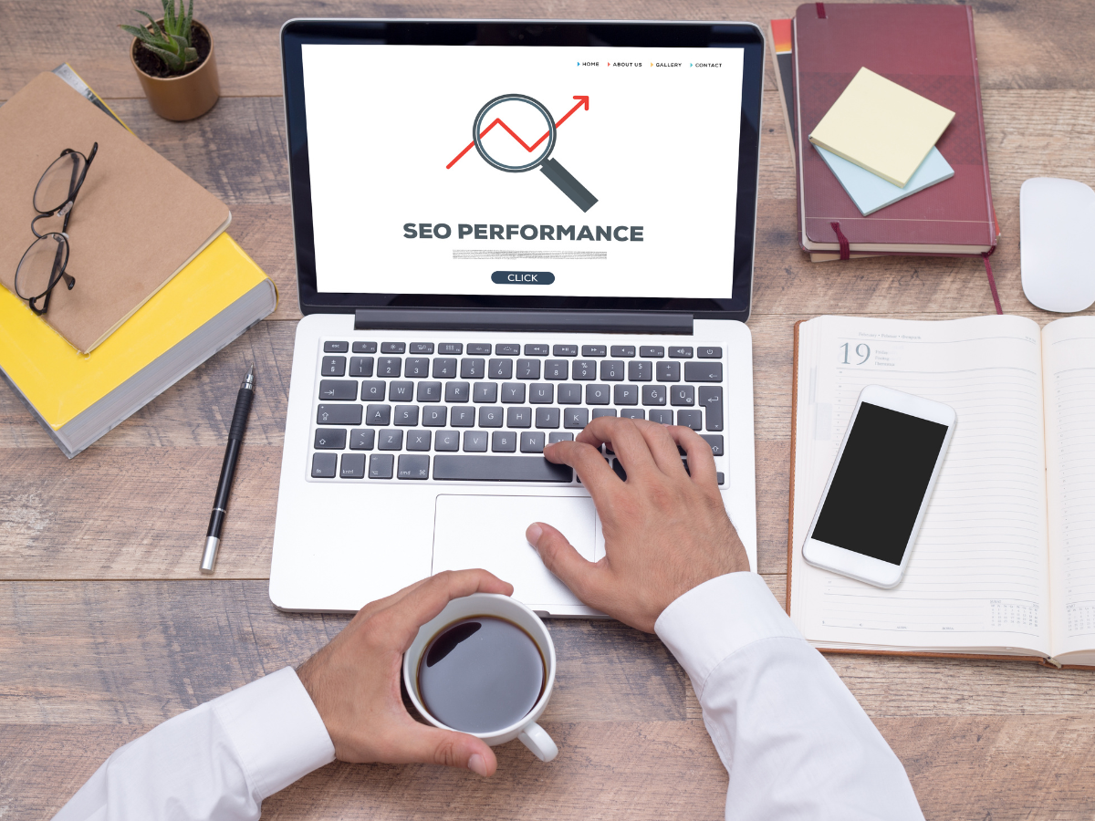 A person is typing on a laptop computer while holding a cup of coffee. A person is typing on a laptop computer while holding a cup of coffee.