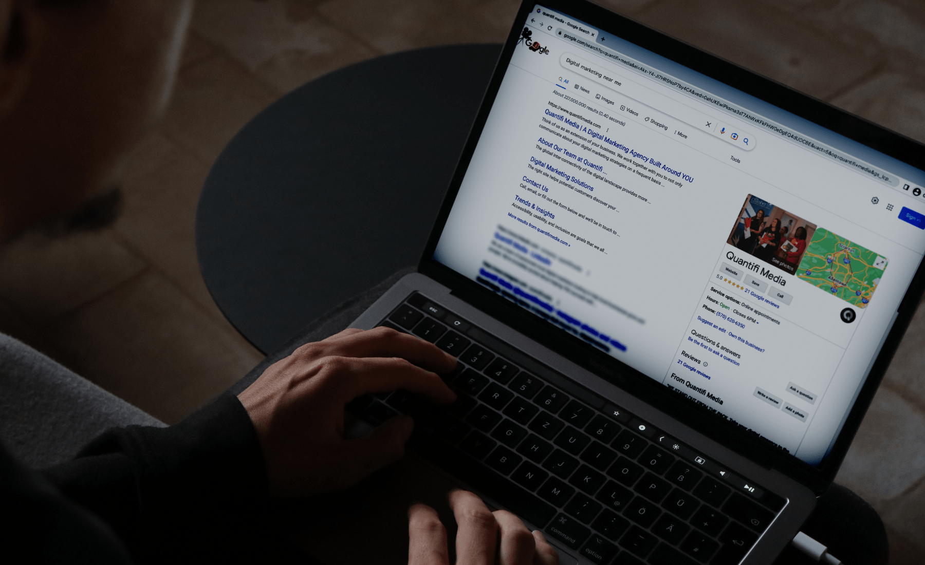 A person is typing on a laptop computer.