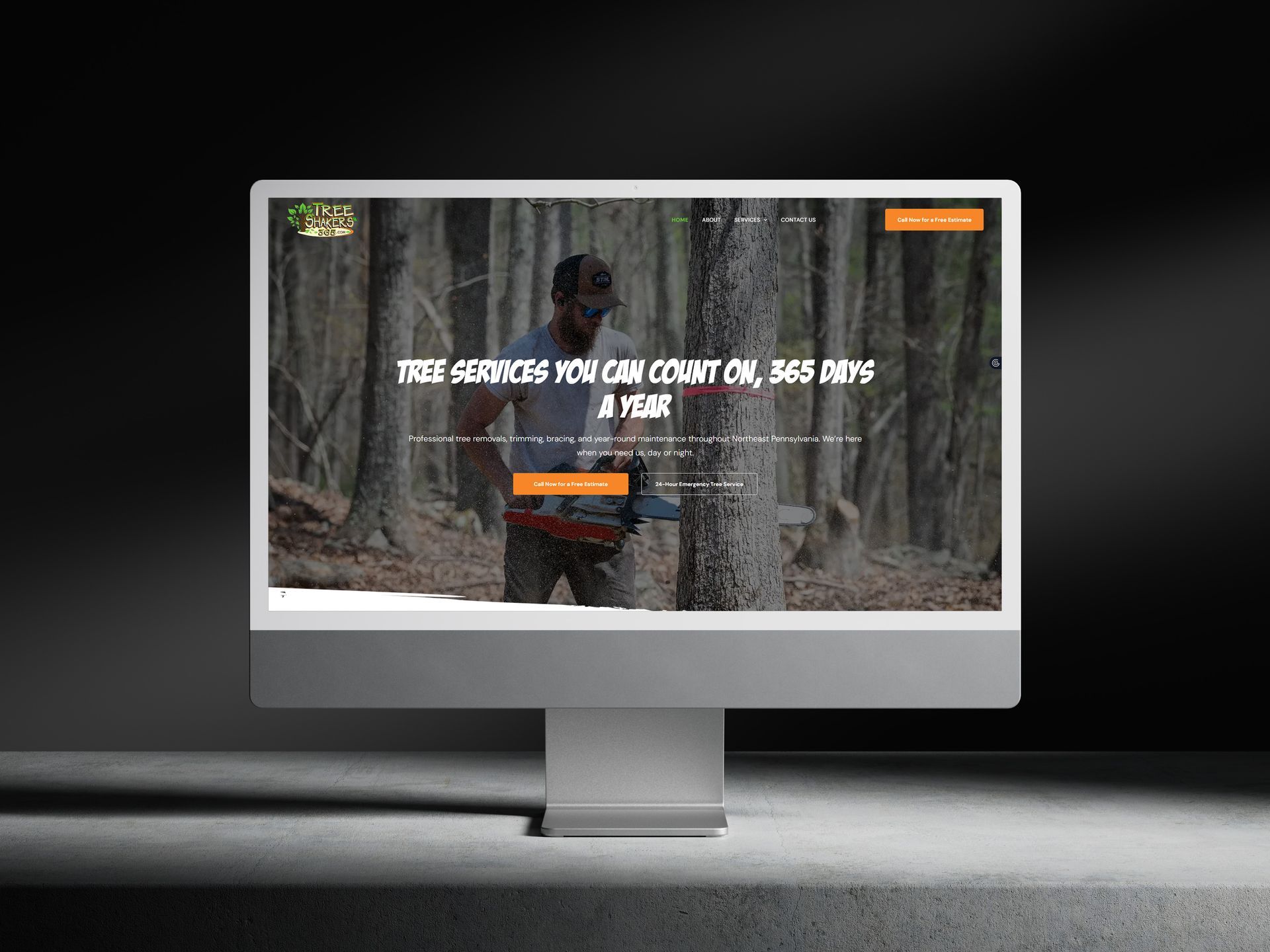 Website on monitor with a man in the woods cutting a tree, and company logo.