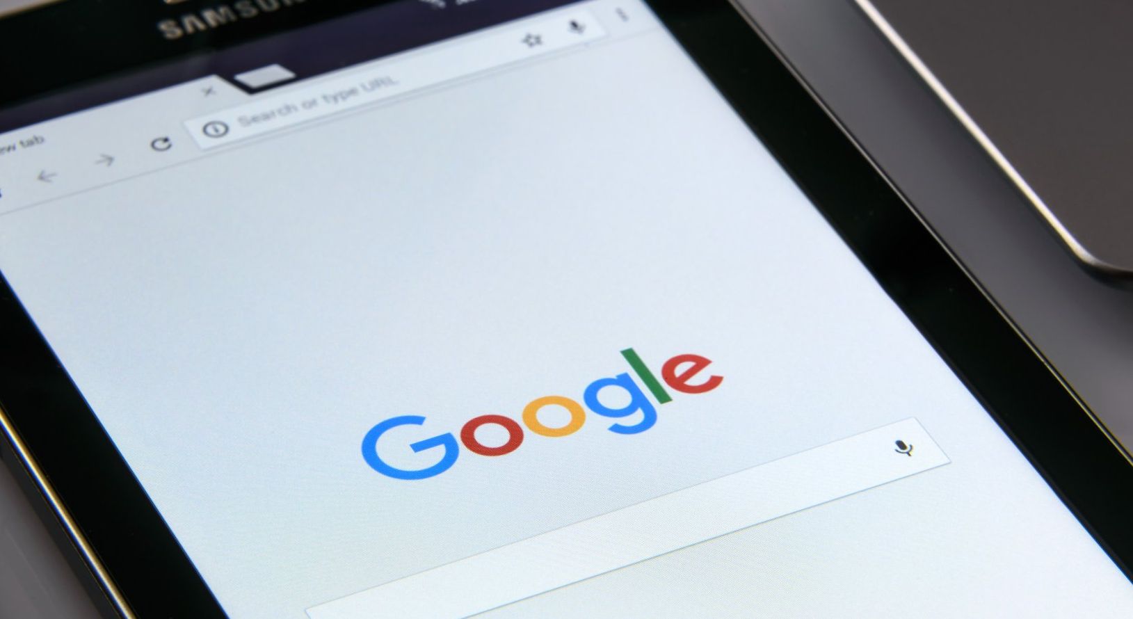 A tablet is open to a google search page.