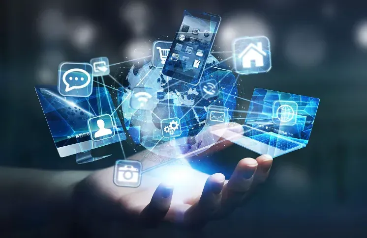 A person is holding a smart phone in their hand with icons coming out of it.