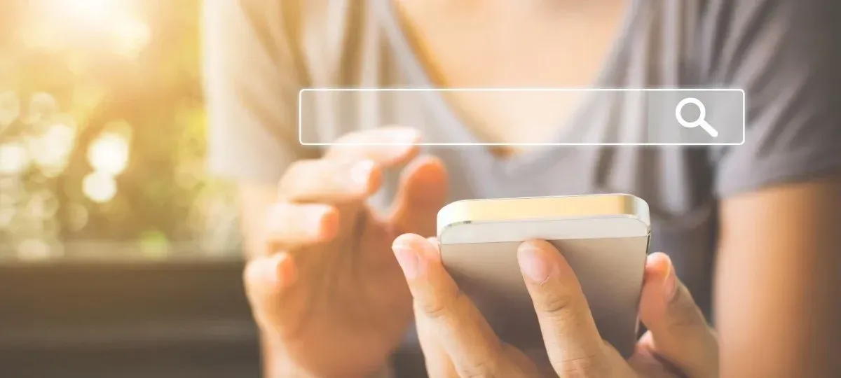 A woman using her phone to search for something online. A woman using her phone to search for something online.