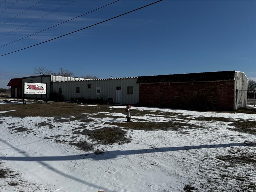 A snowy field with a building in the background