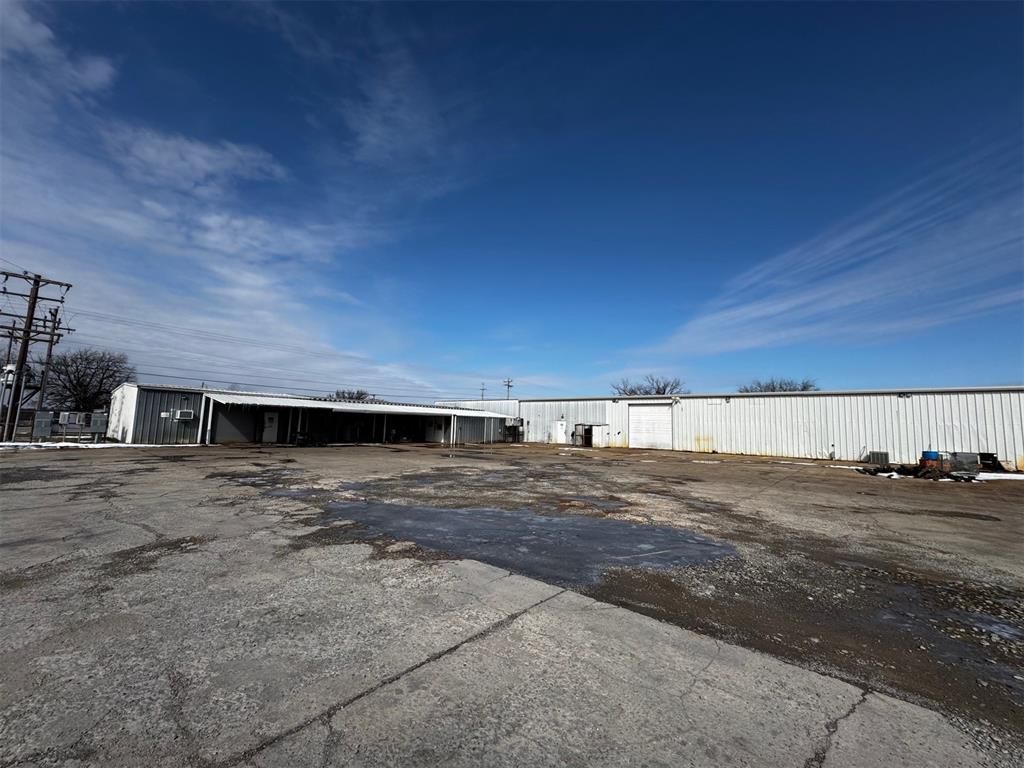 A large white building with a blue sky in the background.