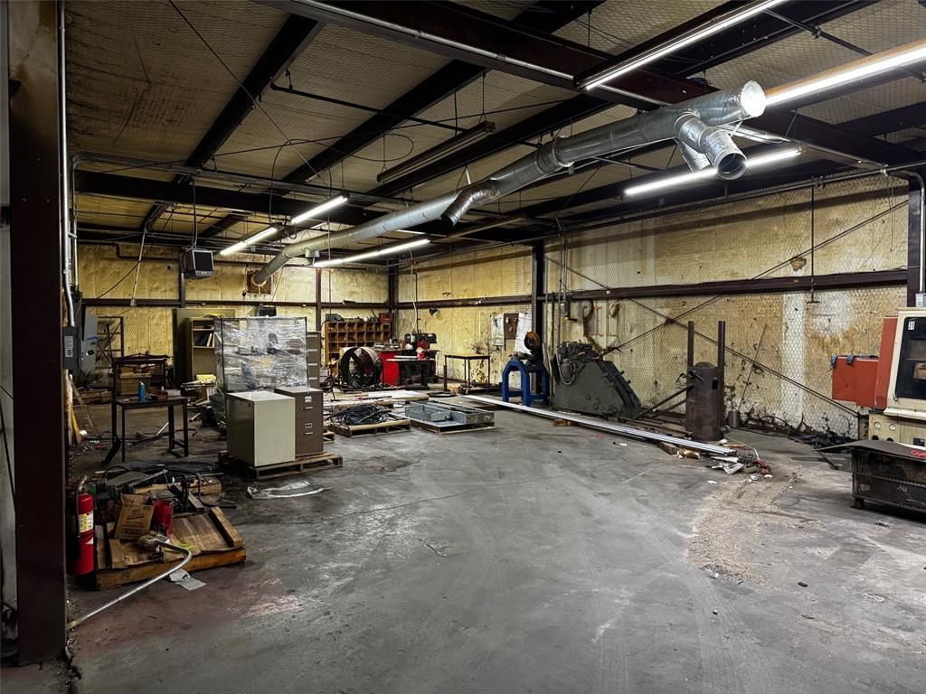 A large warehouse with a lot of machinery in it.