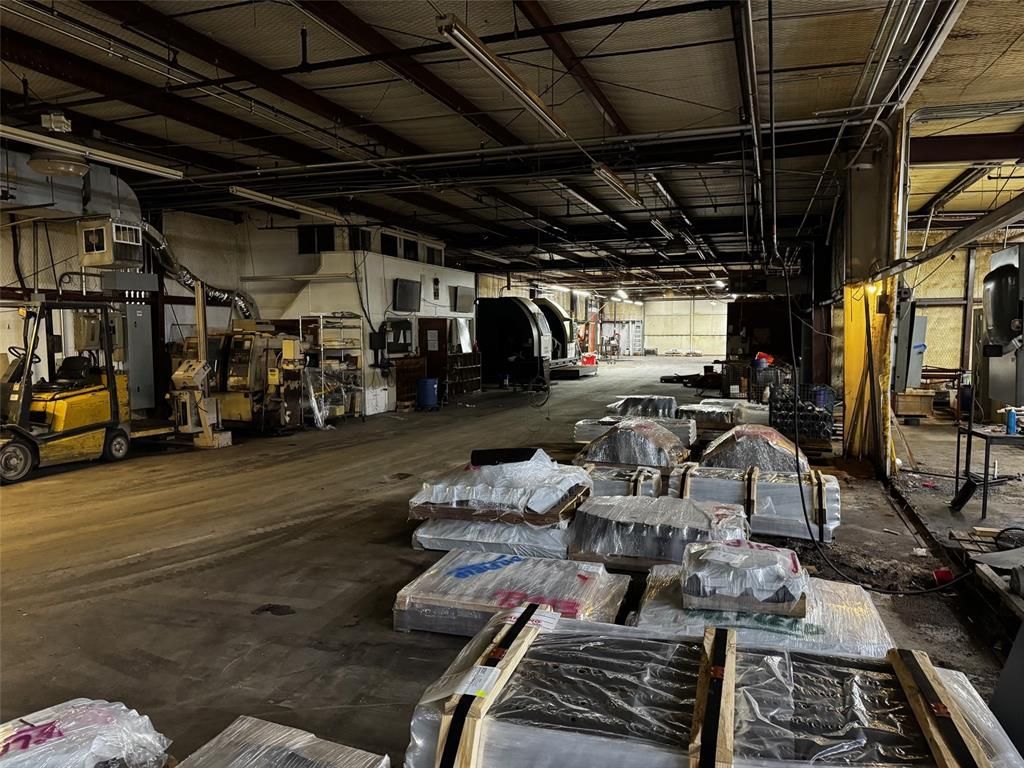 A large warehouse filled with lots of boxes and machinery.