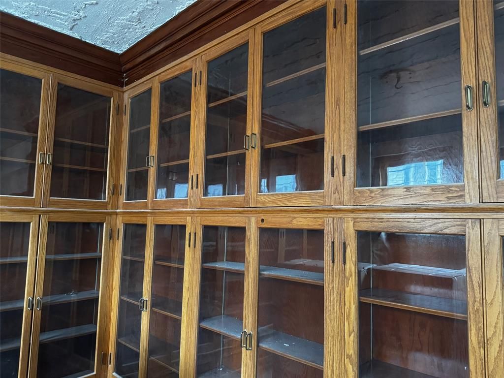 A room with lots of shelves and glass doors
