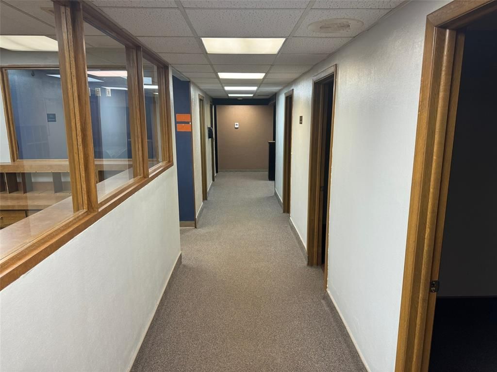 A long hallway with a lot of windows and doors