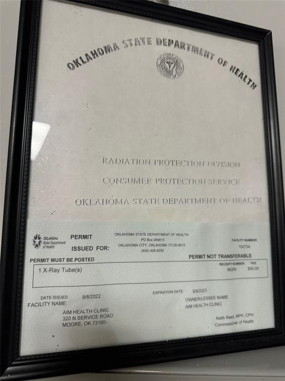 An oklahoma state department of health certificate in a black frame