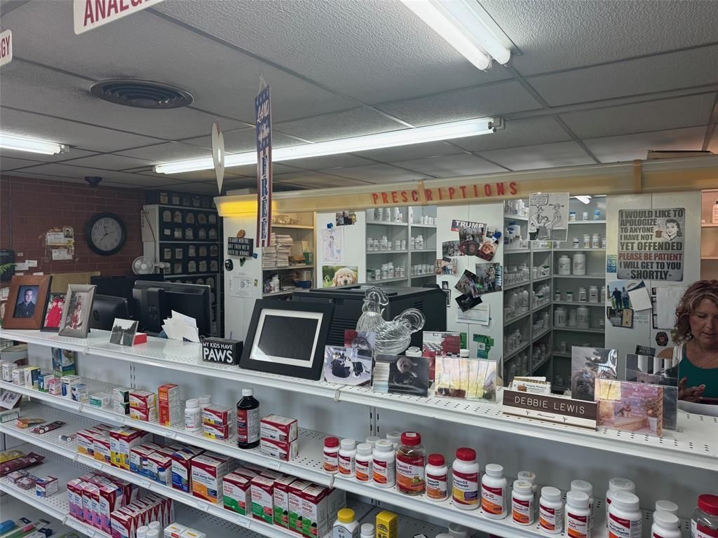 The inside of a pharmacy filled with lots of bottles and shelves.