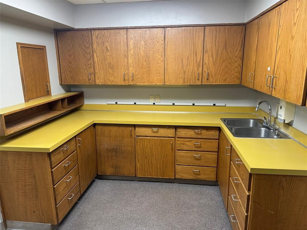 A kitchen with wooden cabinets and yellow counter tops