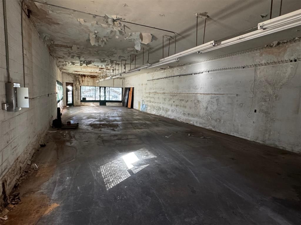A large empty room with a lot of lights on the ceiling