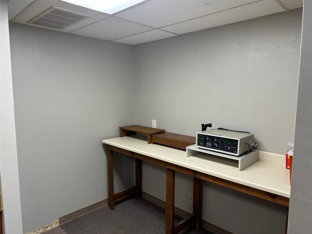 A small room with a table and a microwave on it.