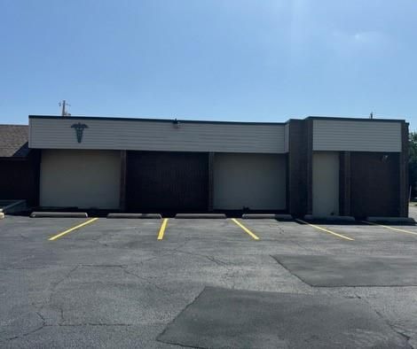 A large building with a parking lot in front of it.