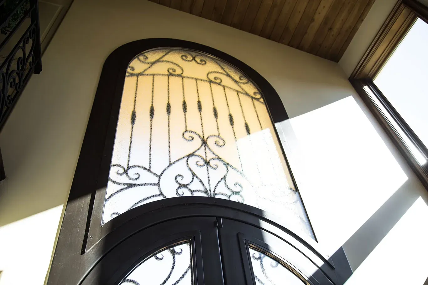 Looking up at a window with a wrought iron fence around it
