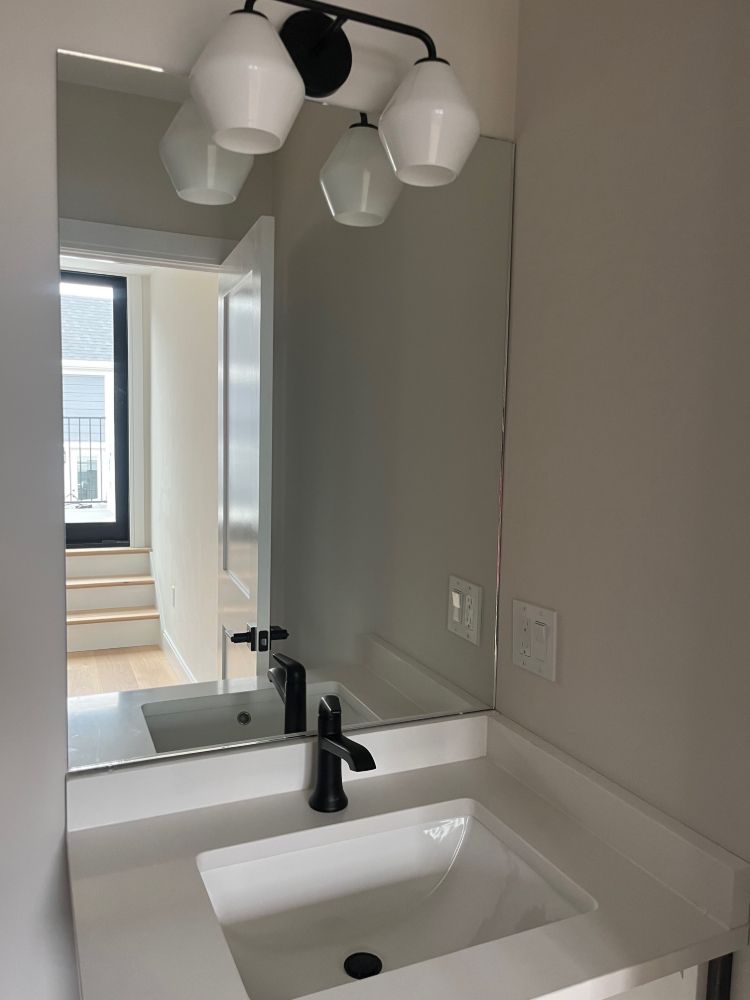 A bathroom with a sink and a mirror