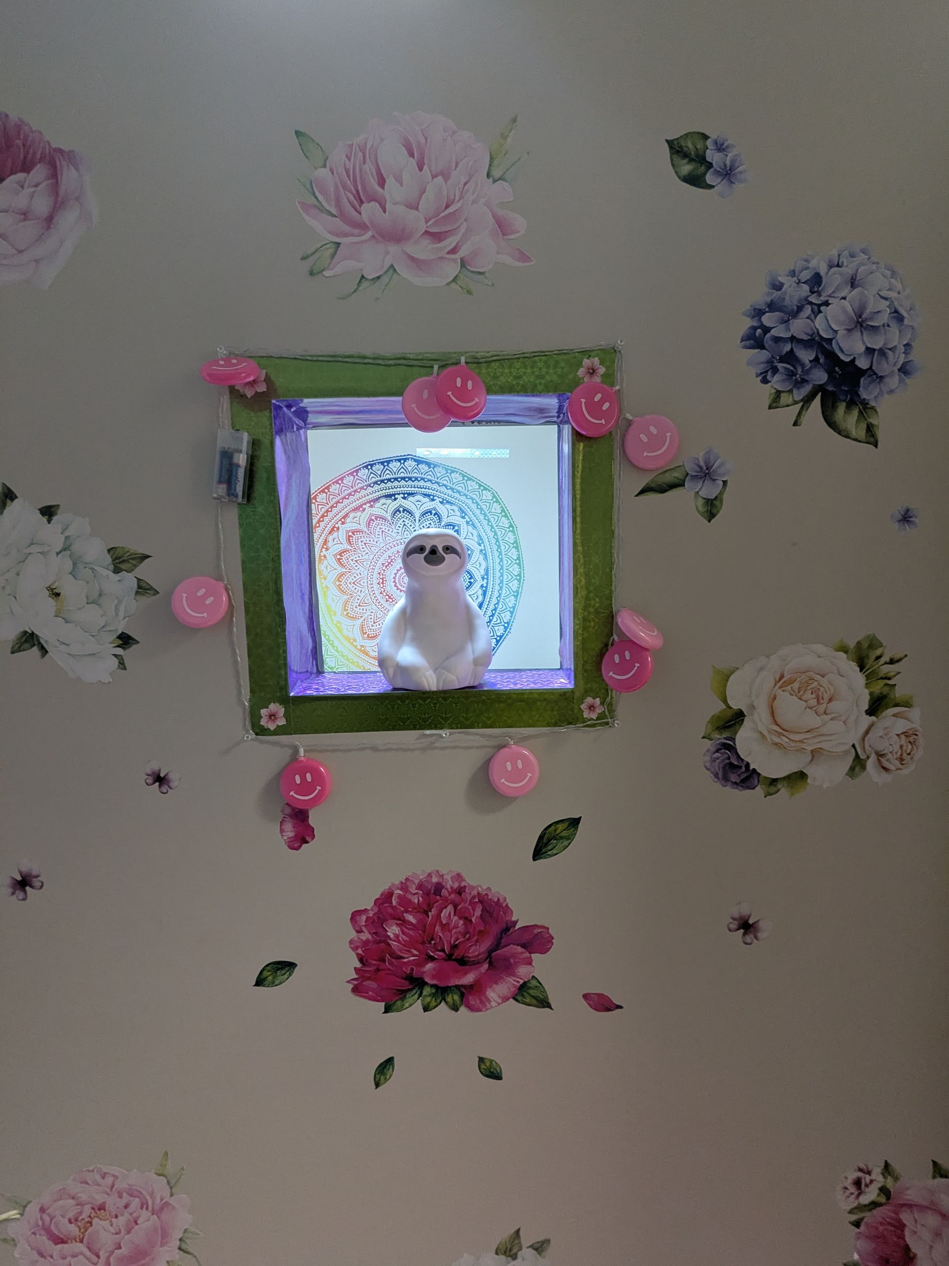 White ceramic owl inside a green-framed window on a floral wallpaper background, with pink decorations.