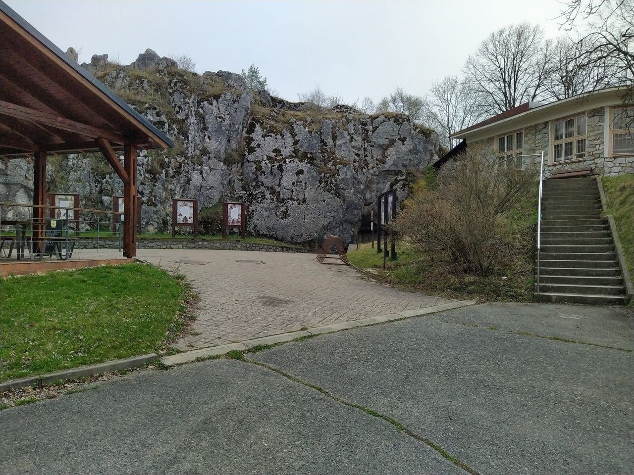 Entrance area of Balcarka Cave below a limestone rock face in the Moravian Karst