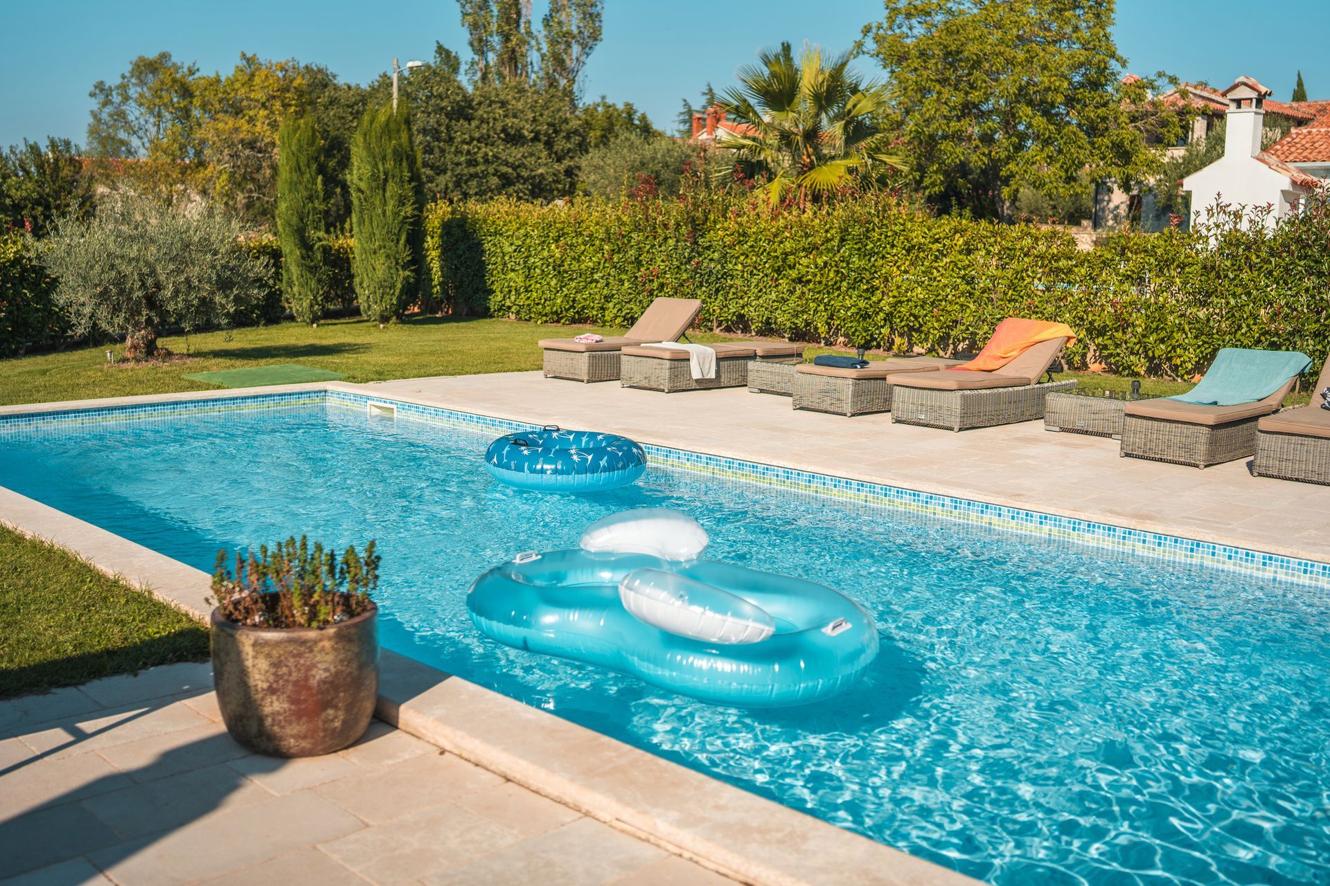 A large swimming pool with a raft in the middle of it.