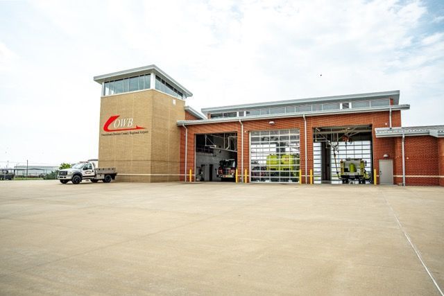 A fire station with a truck parked in front of it.