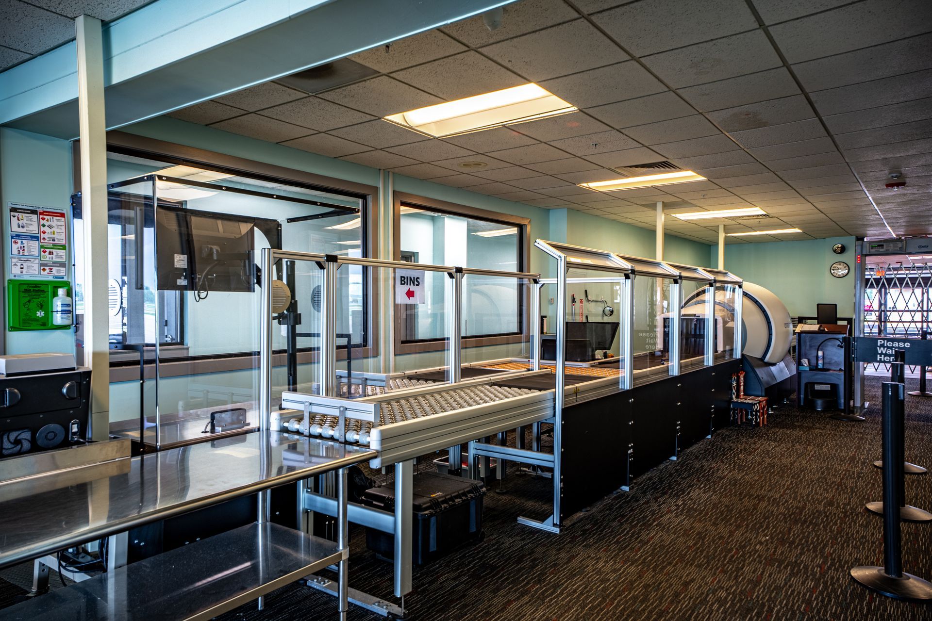 A large room with a conveyor belt in the middle of it.